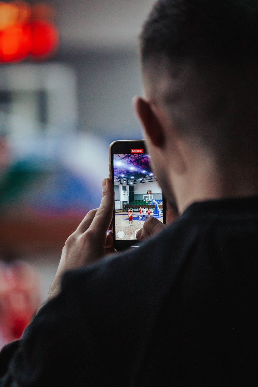 a man is holding a cell phone in front of his face