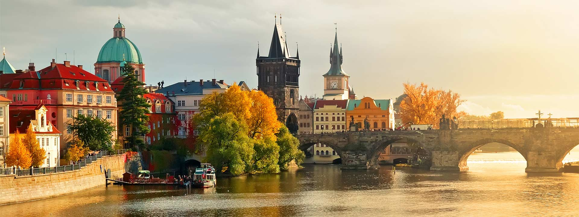 Prague city skyline featuring Charles Bridge and historic buildings along the Vltava River in the Czech Republic.