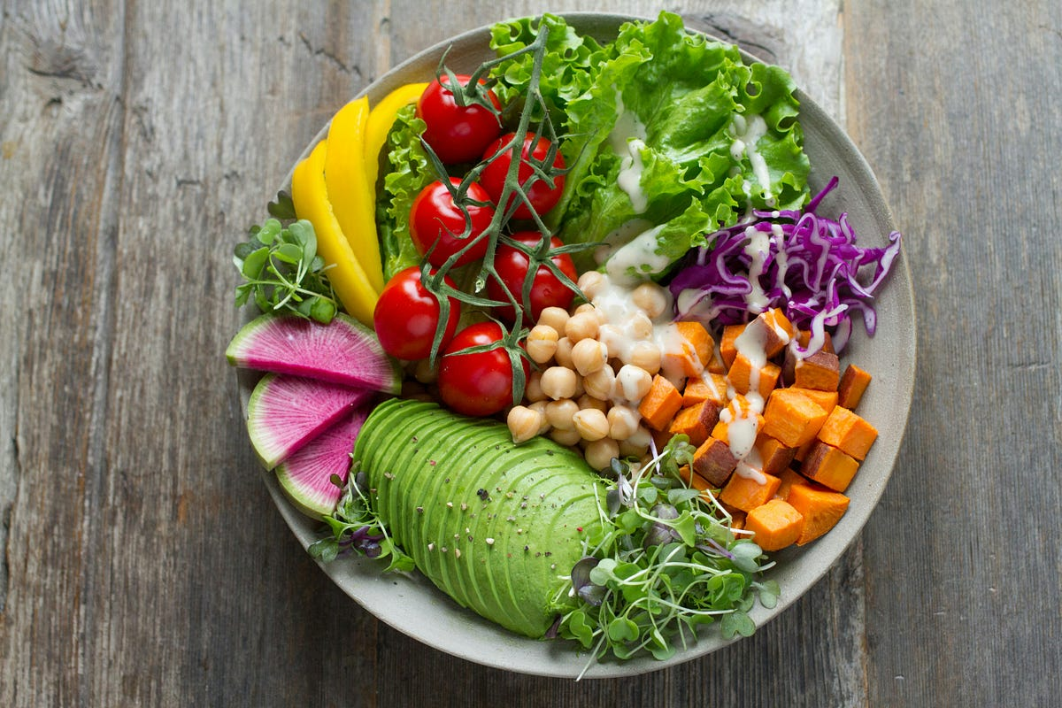 Colorful vegetarian dishes featuring fresh vegetables, salads, pasta, curry, and healthy homemade meals served on a dining table.