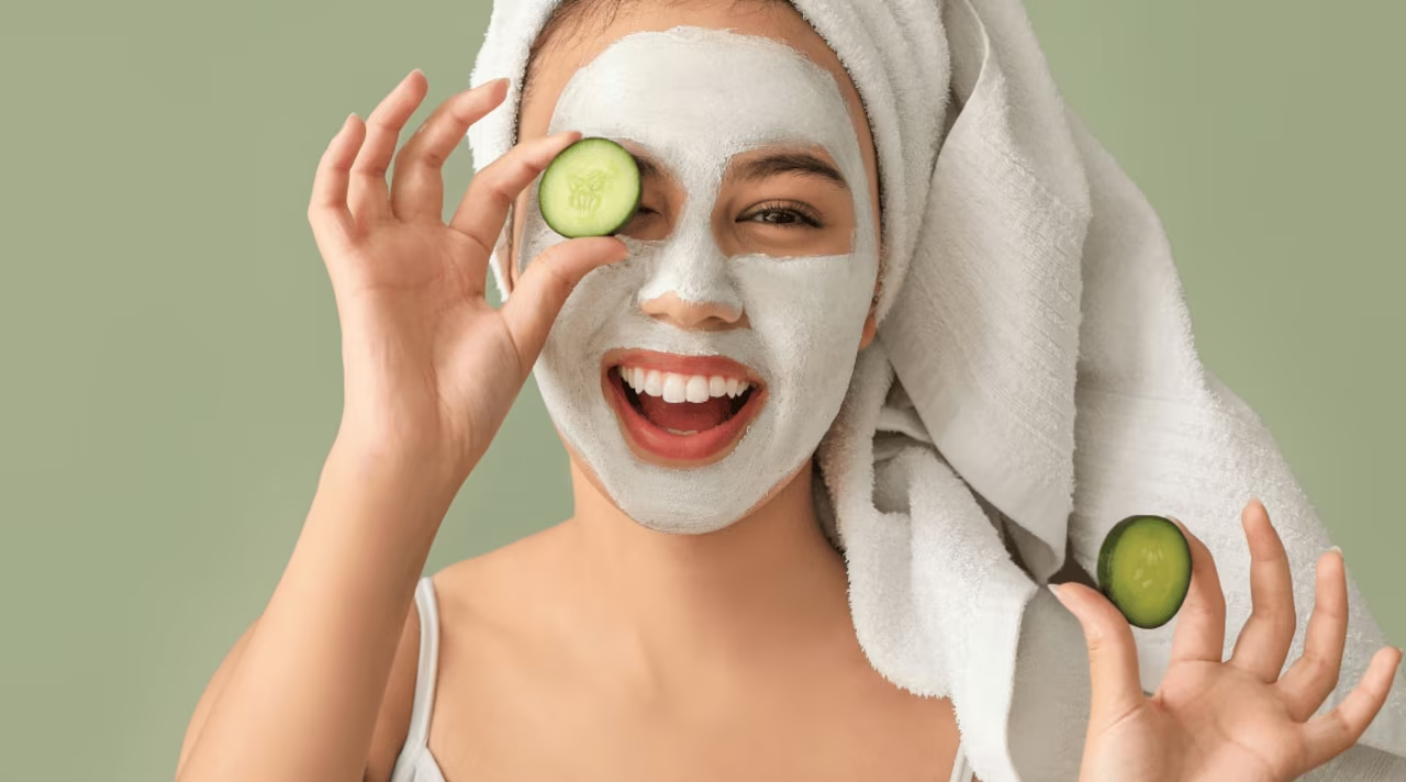 Woman applying a hydrating face mask as part of a gentle skincare routine with face exfoliation tips.